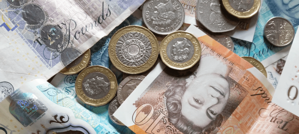 Bank notes and coins piled on top of each other
