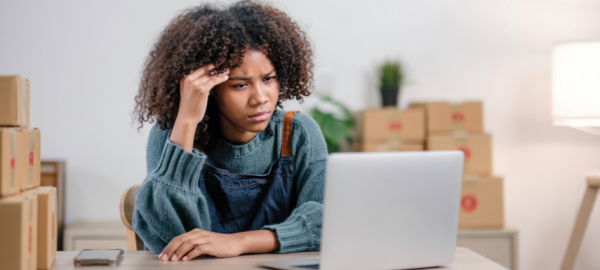 Confused woman frowning at open laptop