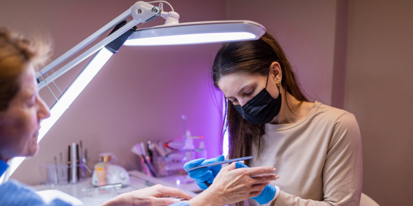 A woman having her nails filed after getting a pedicure near me