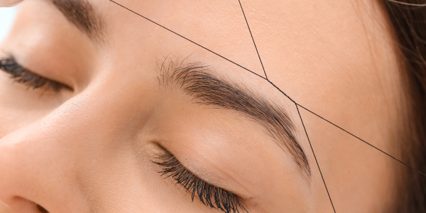A woman receiving eye threading near me up close