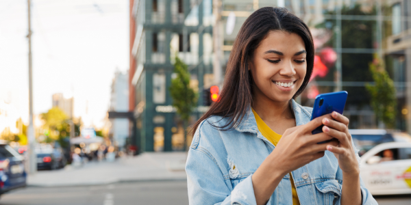 Woman using an online booking system on his smart phone