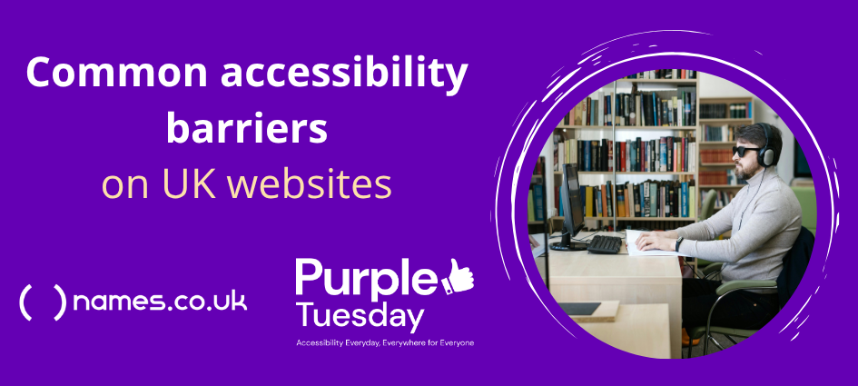 A seated man wearing dark glasses and headphones looks at a computer screen while reading a braille book